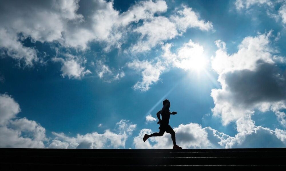 Silhouette of a person jogging.