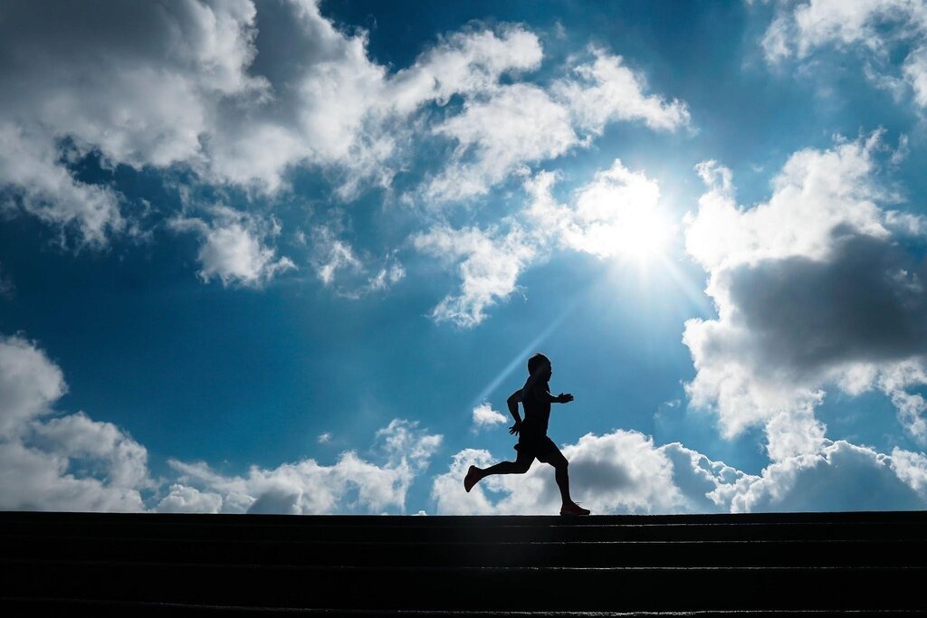 Silhouette of a person jogging.
