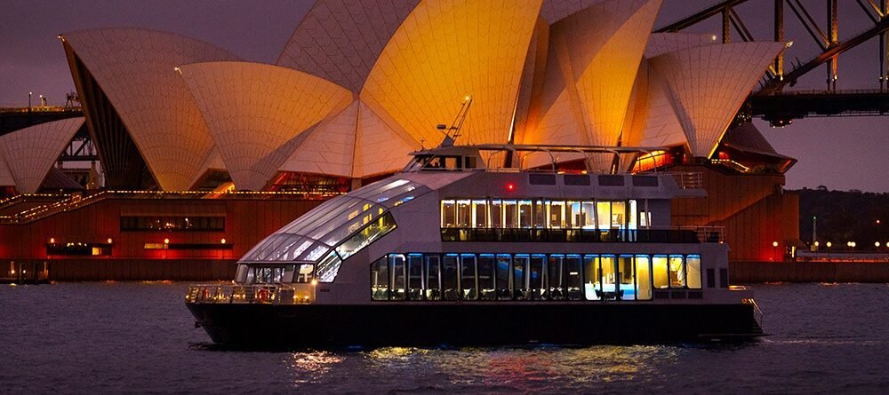 Dinner cruise passing the Sydney Opera House at night