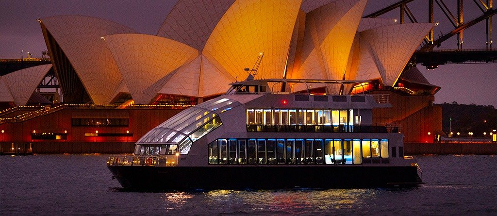 Dinner cruise passing the Sydney Opera House at night