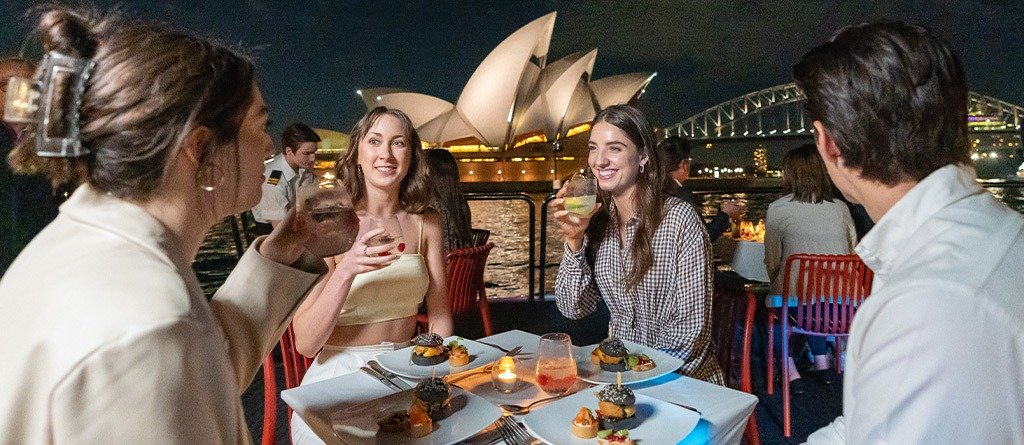 People enjoying dinner aboard a Sydney Harbour cruise
