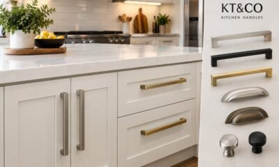 Realistic kitchen interior featuring stylish and durable KT&CO kitchen handles in brushed nickel, matte black, and brass finishes on cream cabinetry.